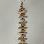 A Little Wood Stacks (Natural) necklace with a chain attached to it.